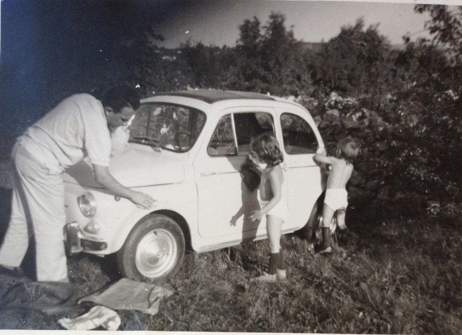 Vintage classic Fiat 500 family washing scene representing heritage